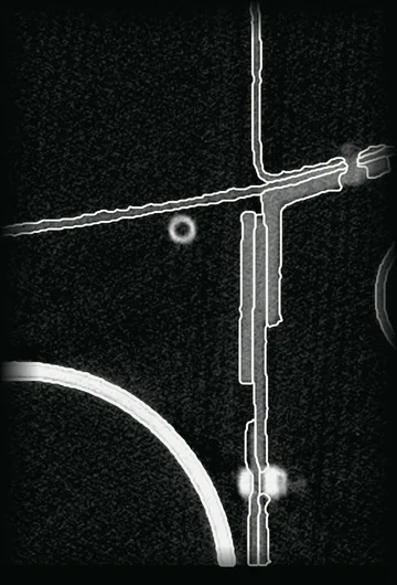 An industrial CT slice through an airframe section, each part outlined in white as the dataset's annotators published it.