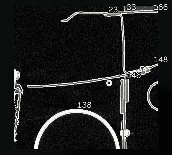 An industrial CT slice of an airframe section with every published part outlined in white and the six largest numbered by their label IDs.