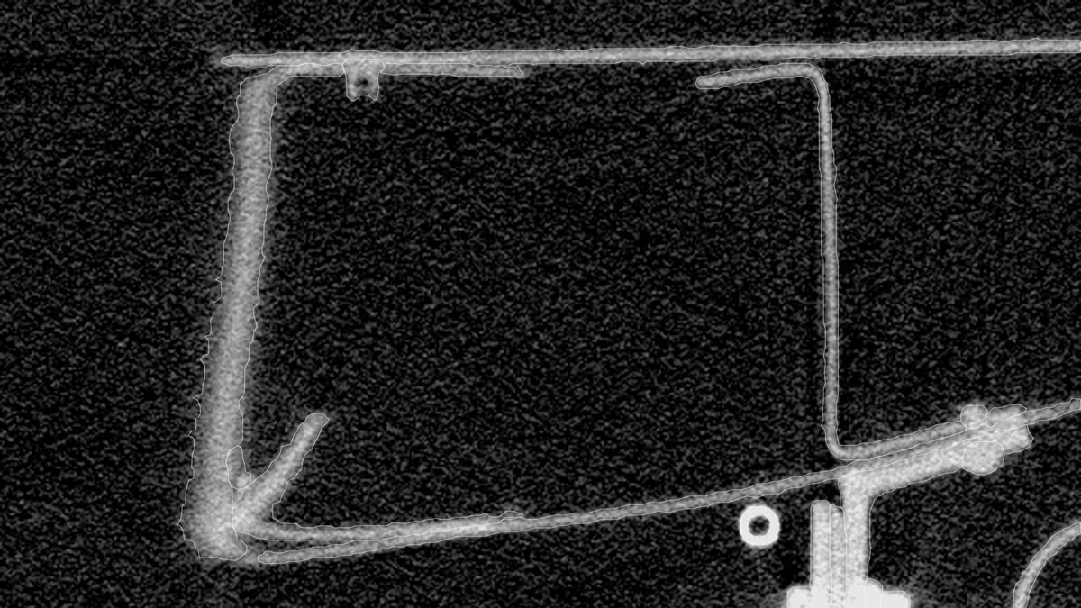 An axial slice of a real industrial CT scan of an airframe section: frames, a stringer and a bracket, each traced by its published outline.